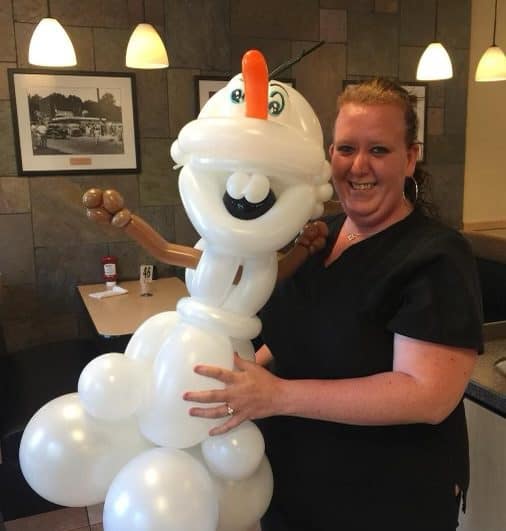 Party Kids America Snowman Balloon Sculpture Woman with snowman balloon sculpture at Party Kids America event.