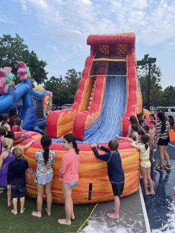 22 FT Blazing Tides Water Slide Rental Kids enjoying the 22 FT Blazing Tides Water Slide at Party Kids America.