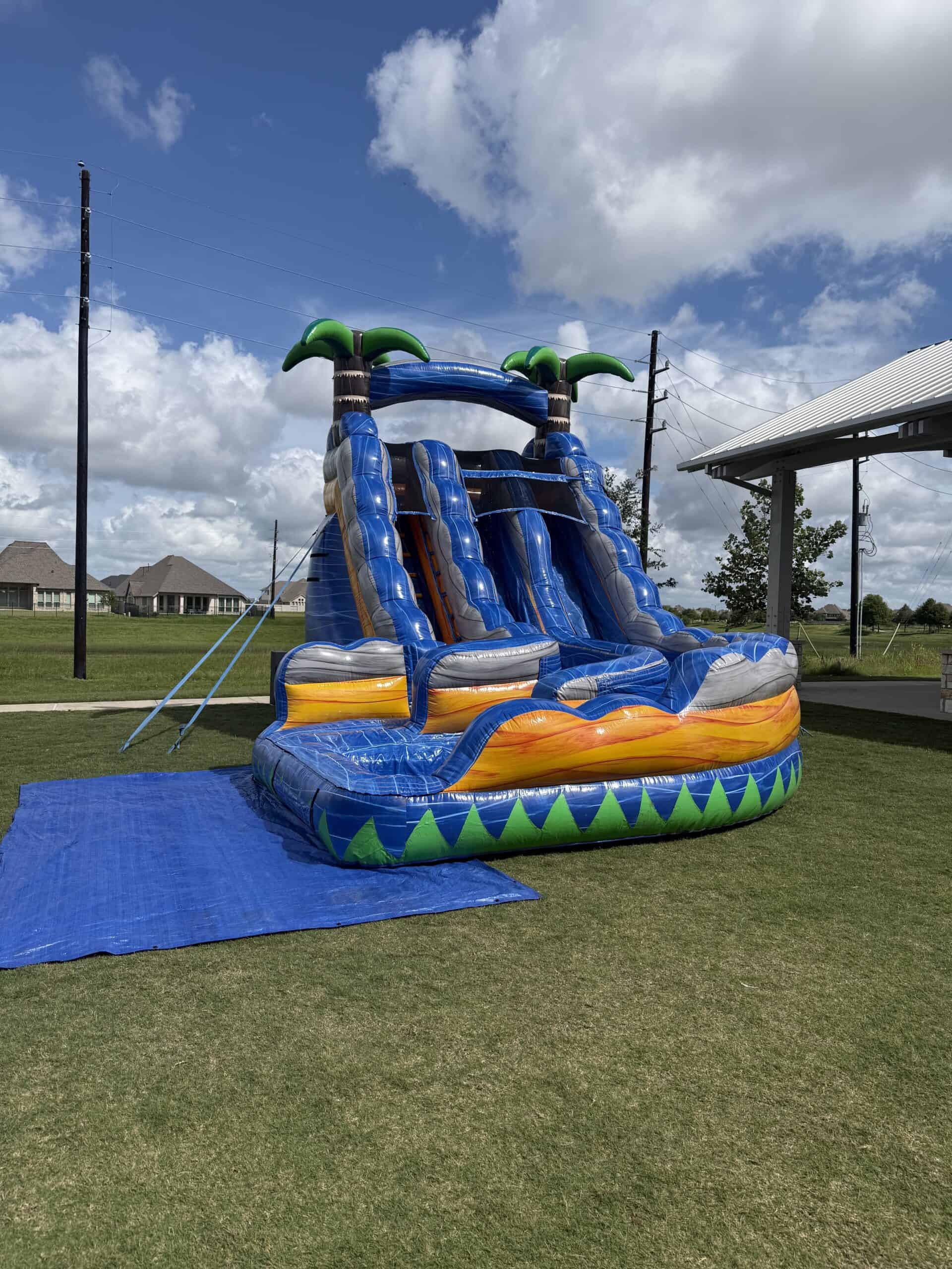 Inflatable Water Slide for Kids Party Colorful inflatable water slide with multiple slides and palm trees for kids' outdoor parties.
