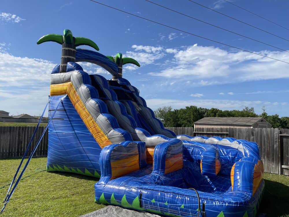 Colorful double curve waterslide for kids outdoor fun at Party Kids America.