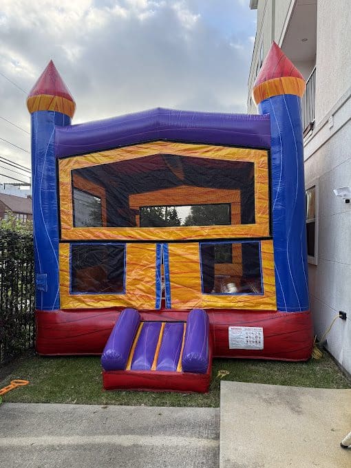 Party Kids Rainbow Bounce House Colorful rainbow bounce house for kids with castle design and slide.