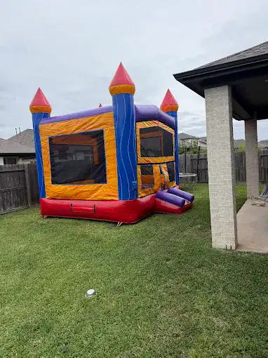 Colorful Castle Bounce House Rental Vibrant inflatable castle bounce house for kids outdoor entertainment.