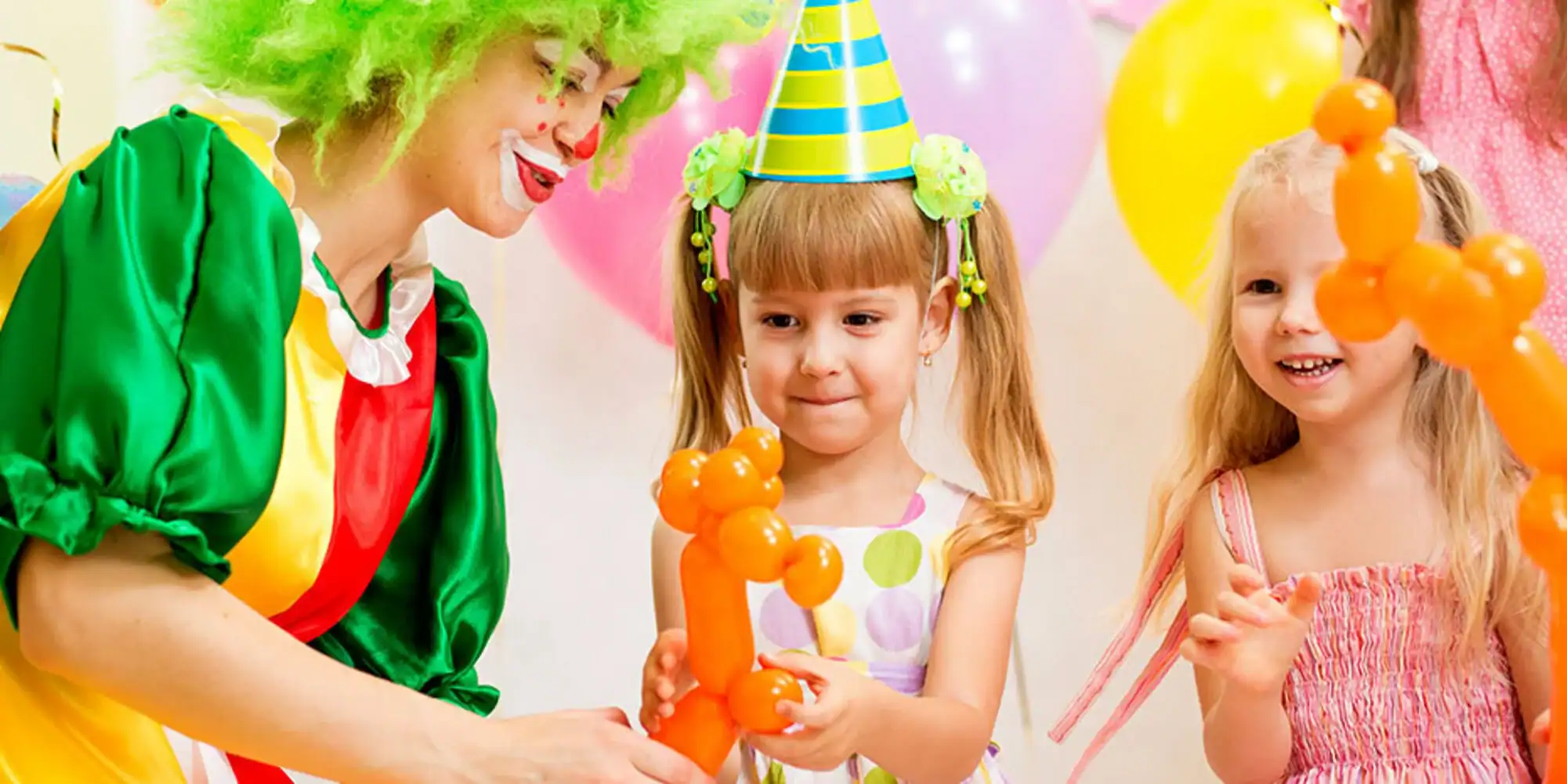 Party Kids America Clown and Children Clown entertaining children at a birthday party with balloons and colorful decorations.